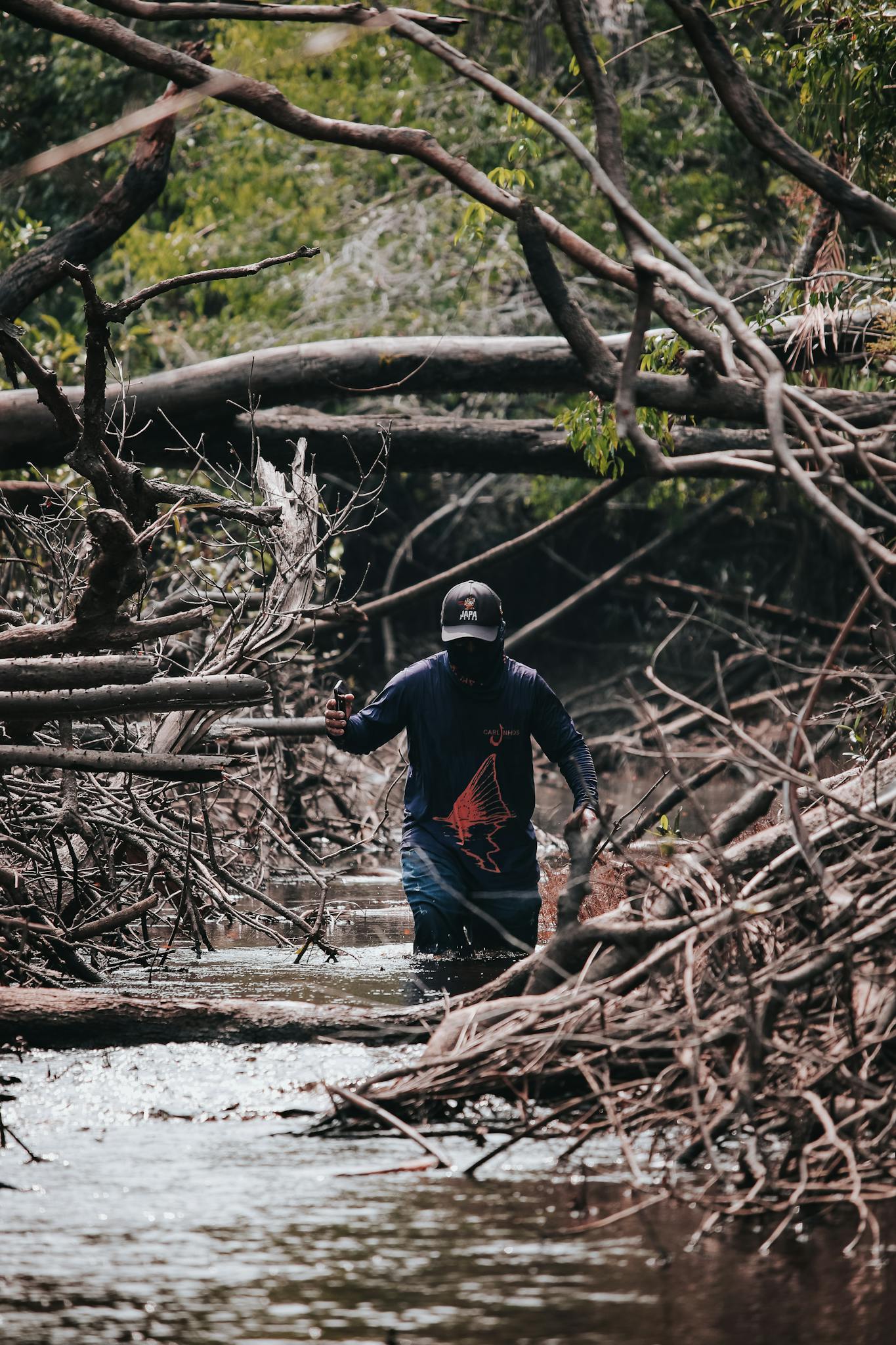 A person navigates through a dense forest along the Amazon River, showcasing the adventure and natural beauty of Amazonia.